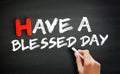 Hand writing Have a Blessed Day on blackboard, concept background