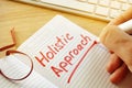 Hand writing Holistic approach in the note. Royalty Free Stock Photo