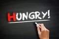 Hand writing Hungry! on blackboard, business concept background Royalty Free Stock Photo