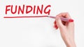 Hand writing inscription funding with marker, concept, stock image