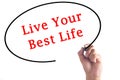 Hand writing Live Your Best Life on transparent board Royalty Free Stock Photo