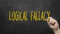 Hand writing logical fallacy text on blackboard Royalty Free Stock Photo