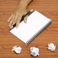 Hand writing on notebook with crumpled paper Royalty Free Stock Photo