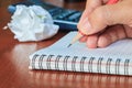 Hand writing notes book on wood table, selective focus. Royalty Free Stock Photo