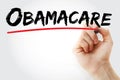 Hand writing Obamacare with red marker, health concept Royalty Free Stock Photo