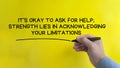 Hand writing It is okay to for help affirmation on yellow cover background. Affirmation concept.