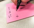 Hand writing with pen on a sheet of paper post-it Royalty Free Stock Photo