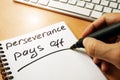 Hand is writing perseverance pays off. Royalty Free Stock Photo