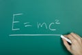 Hand writing relativity formula on blackboard Royalty Free Stock Photo
