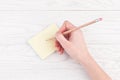 Hand writing on reminder notes with wood pencil Royalty Free Stock Photo