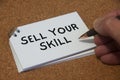 Hand writing sell your skill text on white notepad. Skill concept Royalty Free Stock Photo