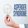 Hand writing sign Asperger Syndrome. Concept meaning characterized as a distinct autism spectrum disorder Hand holding