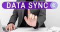 Hand writing sign Data Sync. Concept meaning data that is continuously generated by different sources