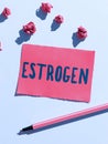 Hand writing sign Estrogen. Word Written on Group of hormones promote the development of female characteristics