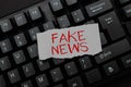 Hand writing sign Fake News. Business overview false information publish under the guise of being authentic news