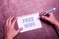 Hand writing sign Free Wifi. Business concept let you connect to the Internet in public places without paying Writing Royalty Free Stock Photo