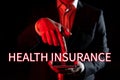 Hand writing sign Health Insurance. Internet Concept reimburse the insured for expenses incurred from illness
