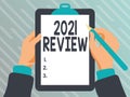 Hand writing sign 2021 Review. Business overview remembering past year events main actions or good shows Playing