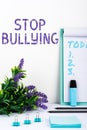 Hand writing sign Stop Bullying. Word for voicing out their campaign against violence towards victims