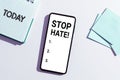 Hand writing sign Stop Hate. Internet Concept Prevent the aggressive pressure or intimidation to others