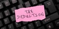 Hand writing sign Tax Deduction. Concept meaning amount subtracted from income before calculating tax owe