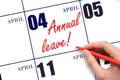 Hand writing the text ANNUAL LEAVE and drawing the sun on the calendar date April 4