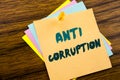Hand writing text caption inspiration showing Anti Corruption. Business concept for Bribery Corrupt Text written on sticky note pa