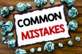 Hand writing text caption inspiration showing Common Mistakes. Business concept for Common Concept Written on sticky note paper, w Royalty Free Stock Photo