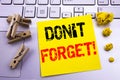 Hand writing text caption inspiration showing Do Not Forget. Business concept for Reminder Message written on sticky note paper on Royalty Free Stock Photo