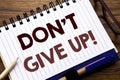 Hand writing text caption inspiration showing Don t Give Up. Business concept for Motivation Determination, Written on notebook no
