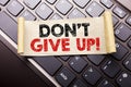 Hand writing text caption inspiration showing Don t Give Up. Business concept for Motivation Determination, written on sticky note Royalty Free Stock Photo