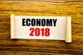 Hand writing text caption inspiration showing Economy 2018. Business concept for Word finance Future Plan written on sticky note