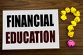 Hand writing text caption inspiration showing Financial Education. Business concept for Finance Knowledge written on white note pa