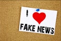 Hand writing text caption inspiration showing I Love Fake News concept meaning Propaganda Newspaper Fake News Loving written on st Royalty Free Stock Photo