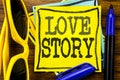 Hand writing text caption inspiration showing Love Story. Business concept for Loving Someone Heart Written on sticky note paper, Royalty Free Stock Photo