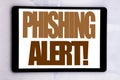 Hand writing text caption inspiration showing Phishing Alert. Business concept for Fraud Warning Danger written on tablet screen o