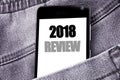 Hand writing text caption inspiration showing 2018 Review. Business concept for Feedback On Progress written mobile cell phone wit