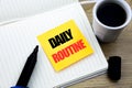 Hand writing text caption inspiration showing Daily Routine. Business concept for Habitual Lifestyle written on sticky note paper,
