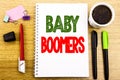 Hand writing text caption showing Baby Boomers. Business concept for Demographic Generation Written on notepad note paper backgrou Royalty Free Stock Photo