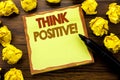 Hand writing text caption showing Think Positive. Business concept for Positivity Attitude Written on sticky note paper, wooden ba Royalty Free Stock Photo