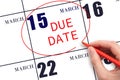 Hand writing text DUE DATE on calendar date March 15 and circling it. Payment due date Royalty Free Stock Photo