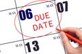 Hand writing text DUE DATE on calendar date May 6 and circling it. Payment due date Royalty Free Stock Photo