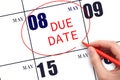 Hand writing text DUE DATE on calendar date May 8 and circling it. Payment due date Royalty Free Stock Photo
