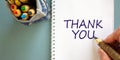Hand writing `thank you`,  on blue background. Bag with pencils. Concept Royalty Free Stock Photo