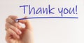 Hand writing Thank You with marker on transparent wipe board