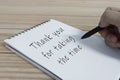 Hand writing thank you for taking the time text on notepad. Royalty Free Stock Photo