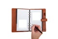 Hand writing to a brown leather journal with two empty polaroid pictures Royalty Free Stock Photo