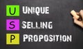 Hand writing USP Unique Selling Proposition with white chalk on Royalty Free Stock Photo