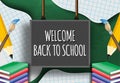 Hand writing welcome back to school on a blackboard. Royalty Free Stock Photo