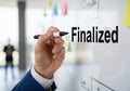 Hand writing the word finalized on a whiteboard with a marker Royalty Free Stock Photo